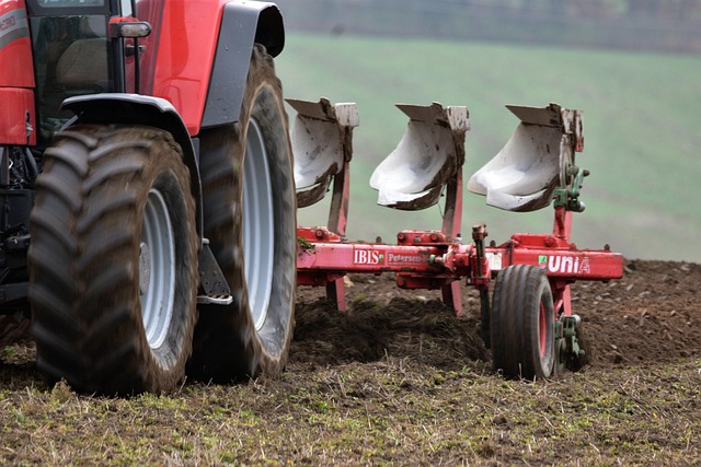 irish farmland field with equipment tracks and soil